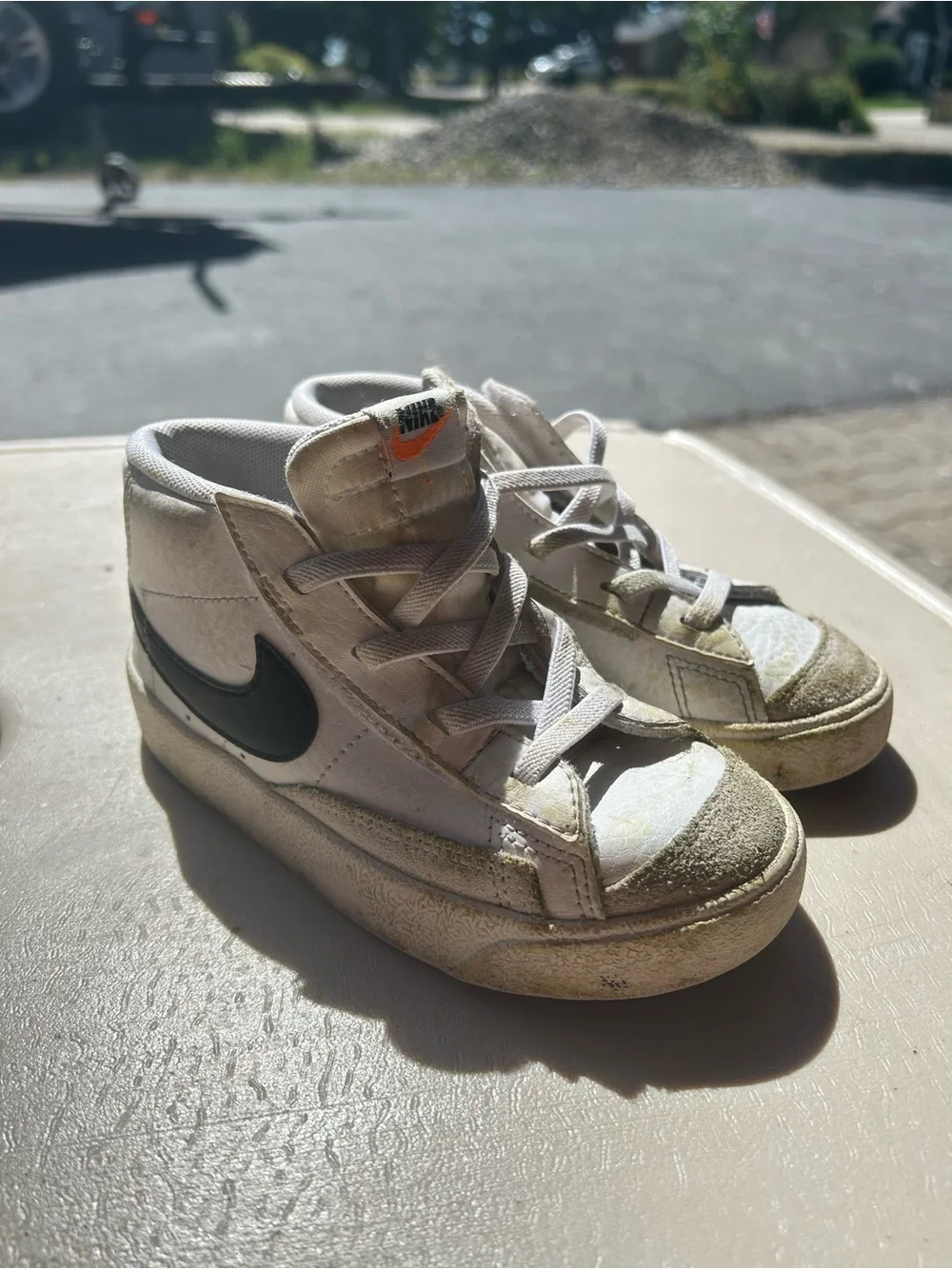 Nike Kids White High-Top Sneakers with Black Swoosh and Orange Tongue Accent